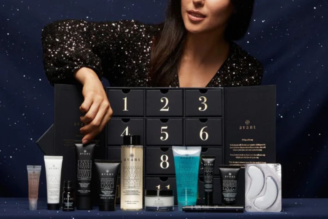woman picking out products from the Avant Dreams Beauty Advent Calendar