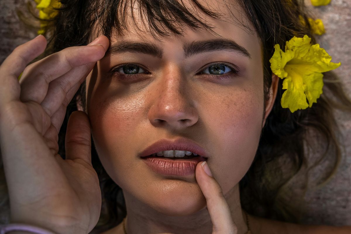 close up of girl's face with flowers in her hair