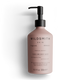 Pink bottle of Wildsmith Skin hand and body wash on a white background