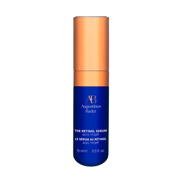Blue serum bottle with orange cap on a white background