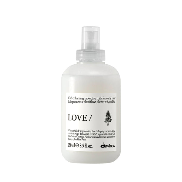 White hair care product bottle with 'LOVE' branding on a white background