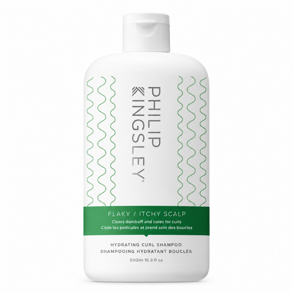 A 500ml white bottle of Philip Kingsley Flaky / Itchy Scalp Hydrating Curl Shampoo, featuring a white cap and a label with green wavy lines and a green band.