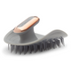 Gray grooming brush with rose gold handle on a white background