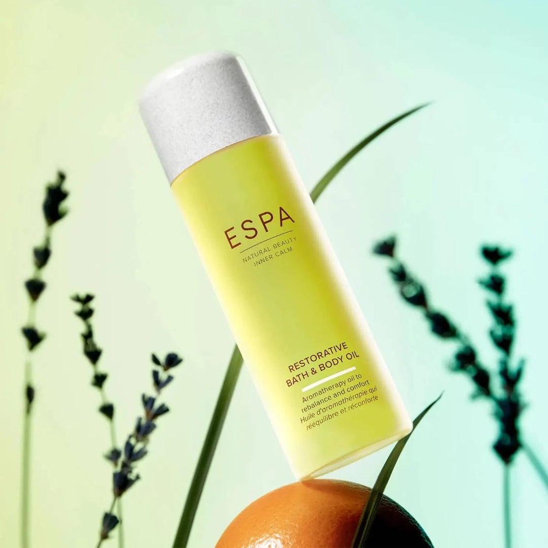 ESPA Restorative Bath and Body Oil on top of an orange