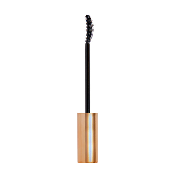 Mascara with gold tube and black brush on a white background