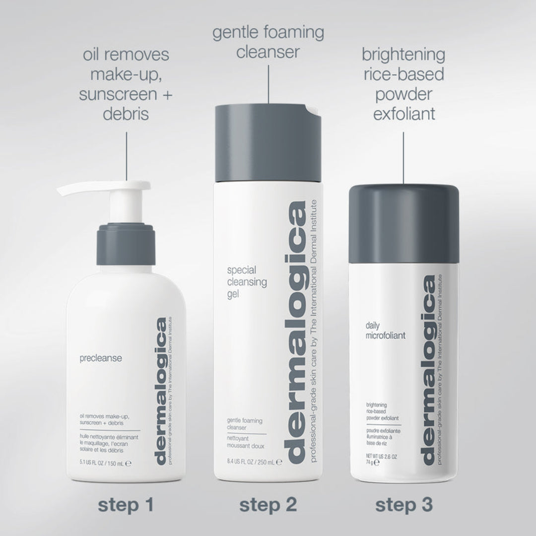 Three Dermalogica skincare bottles arranged on a light gray background with text labels indicating steps: a white pump bottle labeled 'precleanse' at step 1, a white foaming cleanser bottle labeled 'gentle foaming cleanser' at step 2, and a white powder exfoliant bottle labeled 'brightening rice-based powder exfoliant' at step 3.