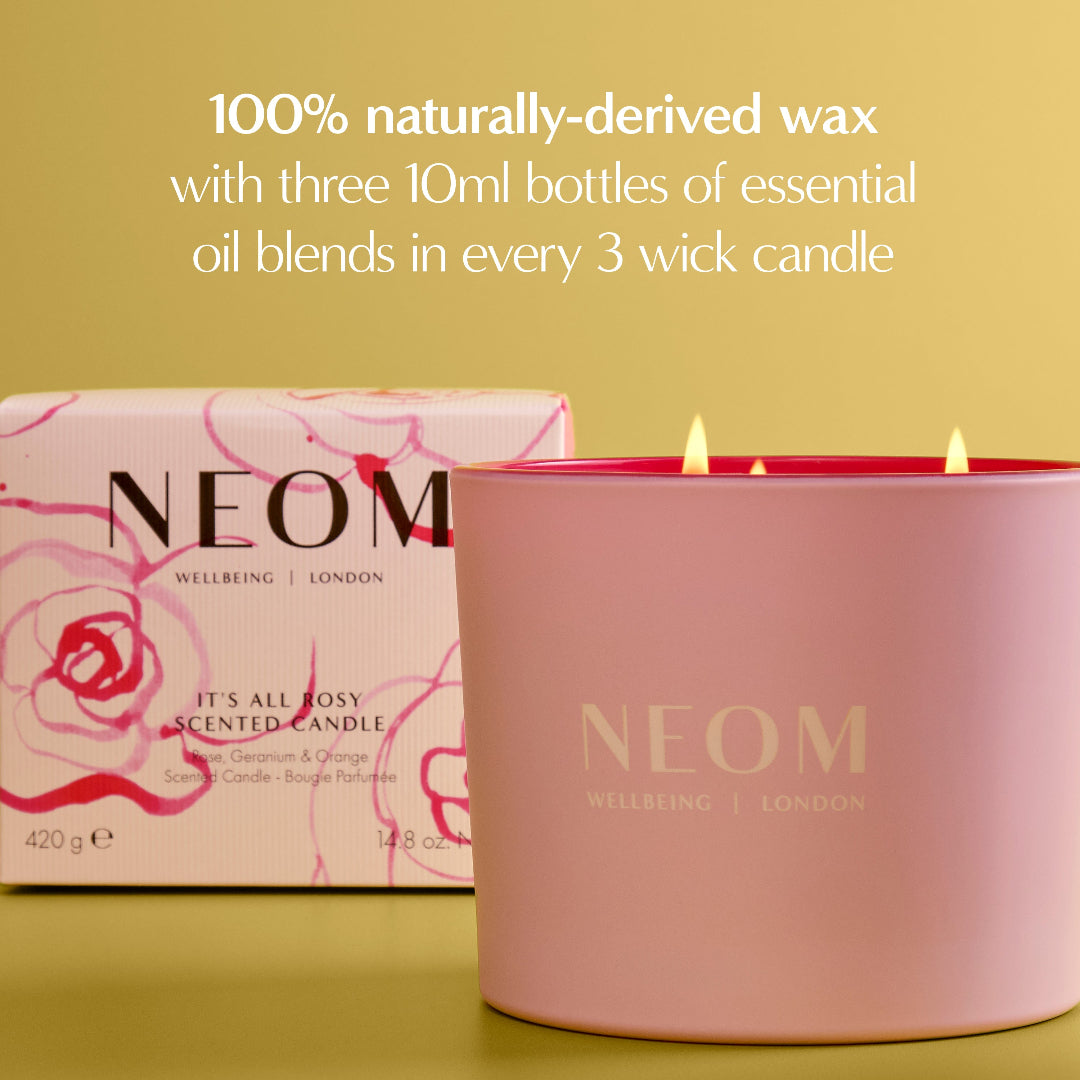 NEOM candle and packaging on a yellow background