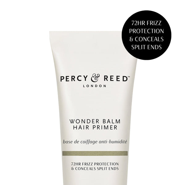 A white squeeze tube of Percy & Reed London Wonder Balm Hair Primer with black text, shown on a white background with a black circular badge in the top right.