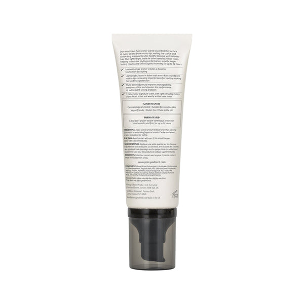 The back of a white squeeze tube with black text, featuring a dark gray pump dispenser, shown on a plain white background.