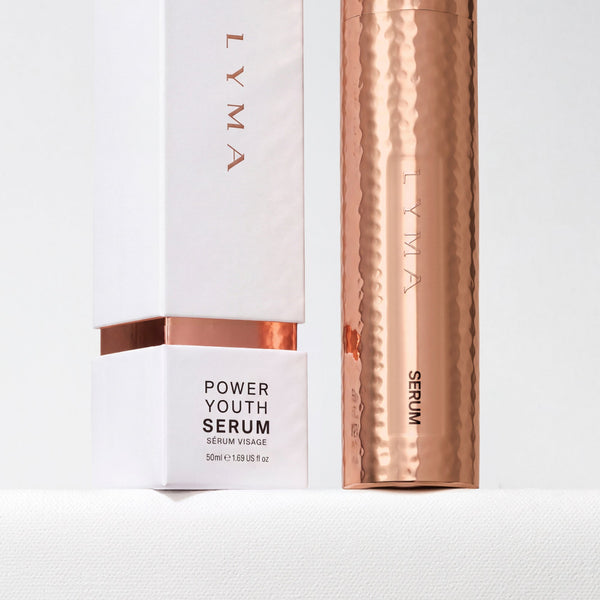LYMA Power Youth Serum shown with its white box and a metallic rose-gold cylindrical tube on a clean white background.