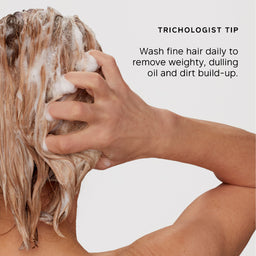 A person washing fine hair with shampoo foam, shown from the back against a light gray background, with the text 'TRICHOLOGIST TIP' and a tip about washing fine hair daily.