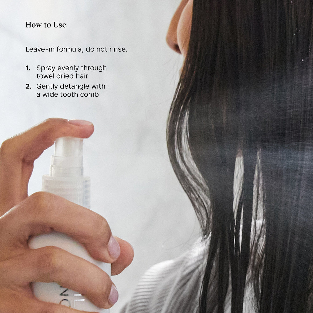 A close-up of a person with long dark hair holding a white spray bottle and spraying hair product onto their hair. Black text on the left reads 'How to Use' with two steps for application.