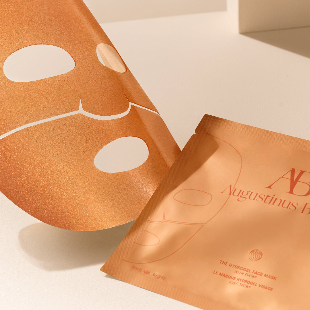 Two Augustinus Bader face masks on a light beige background