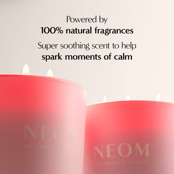 Two pink candles with NEOM branding on a light background, featuring text about natural fragrances.