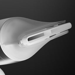 Close-up of a black and white electronic device on a dark background