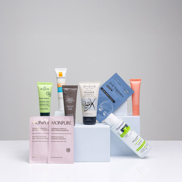 Collection of skincare products on a gray background