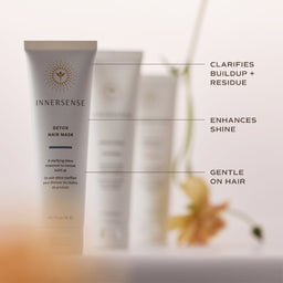 InnerSense Detox Hair Mask tube in a soft beige and white color, shown with feature callout lines and text on a warm, blurred background.
