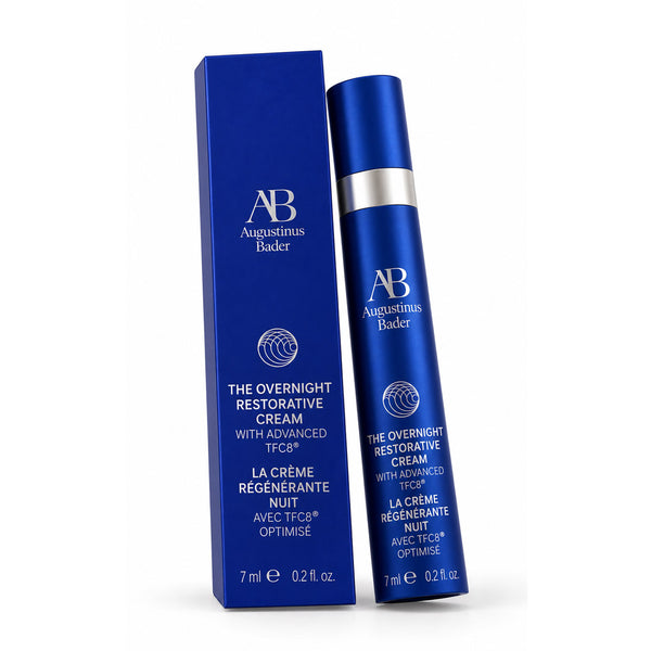 Augustinus Bader The Overnight Restorative Cream shown in a deep blue squeeze bottle next to its matching blue packaging box on a white background.