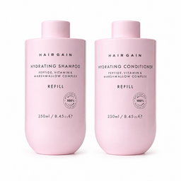 Two light pink Hairgain haircare bottles on a white background: Hydrating Shampoo and Hydrating Conditioner, both labeled REFILL and 250ml.