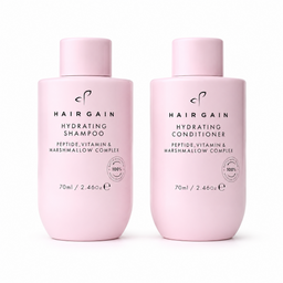 Two light pink bottles of Hairgain haircare products on a white background: Hydrating Shampoo and Hydrating Conditioner, 70ml each.