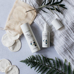 Clinisoothe+ Skin Purifier Bottles surrounded by cotton pads and plants