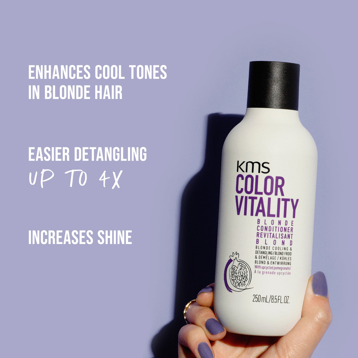 KMS Color Vitality blonde conditioner bottle held by a hand with purple nail polish against a light purple background.