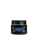 A black jar of d'orés Heart of Glass Intense Treatment with a dark blue label, centered against a solid white background.