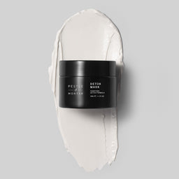 Detox mask container with white mask on a gray background