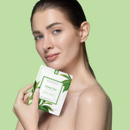 A promotional skincare banner for FOREO Sweden's Farm to Face Collection Green Tea. The left side features a woman holding a green tea facial mask packet against a light green background.