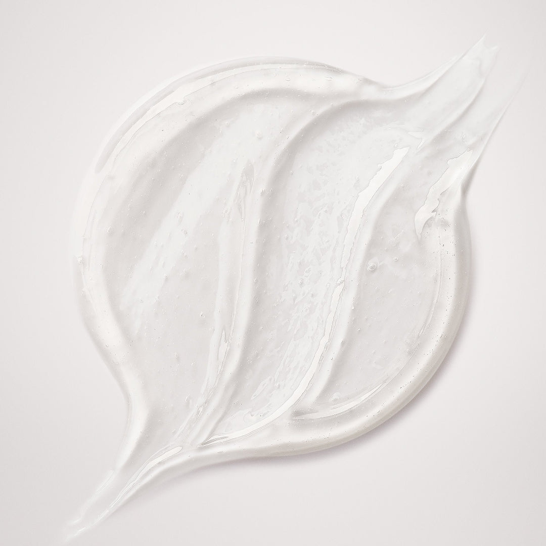 Close-up of white cream or paint on a light gray background