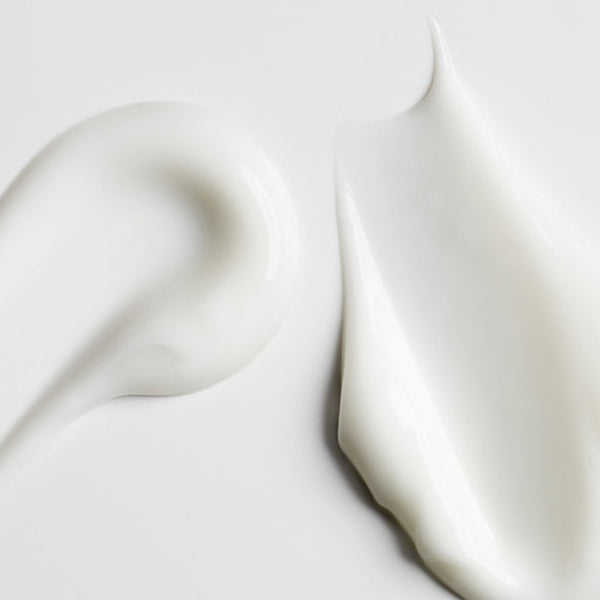 Close-up of white fabric with a soft texture on a light gray background