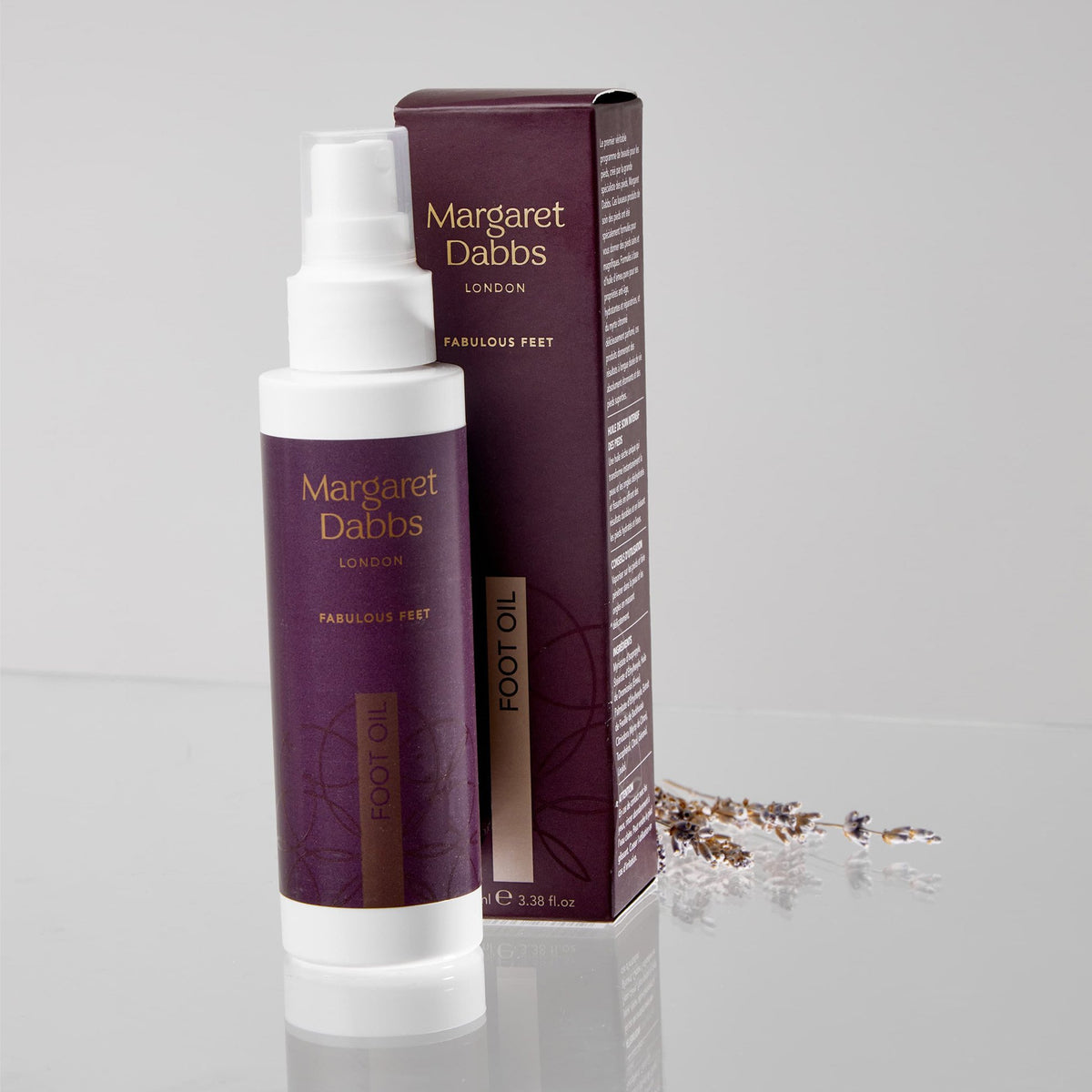 Margaret Dabbs London foot oil bottle and packaging on a gray background
