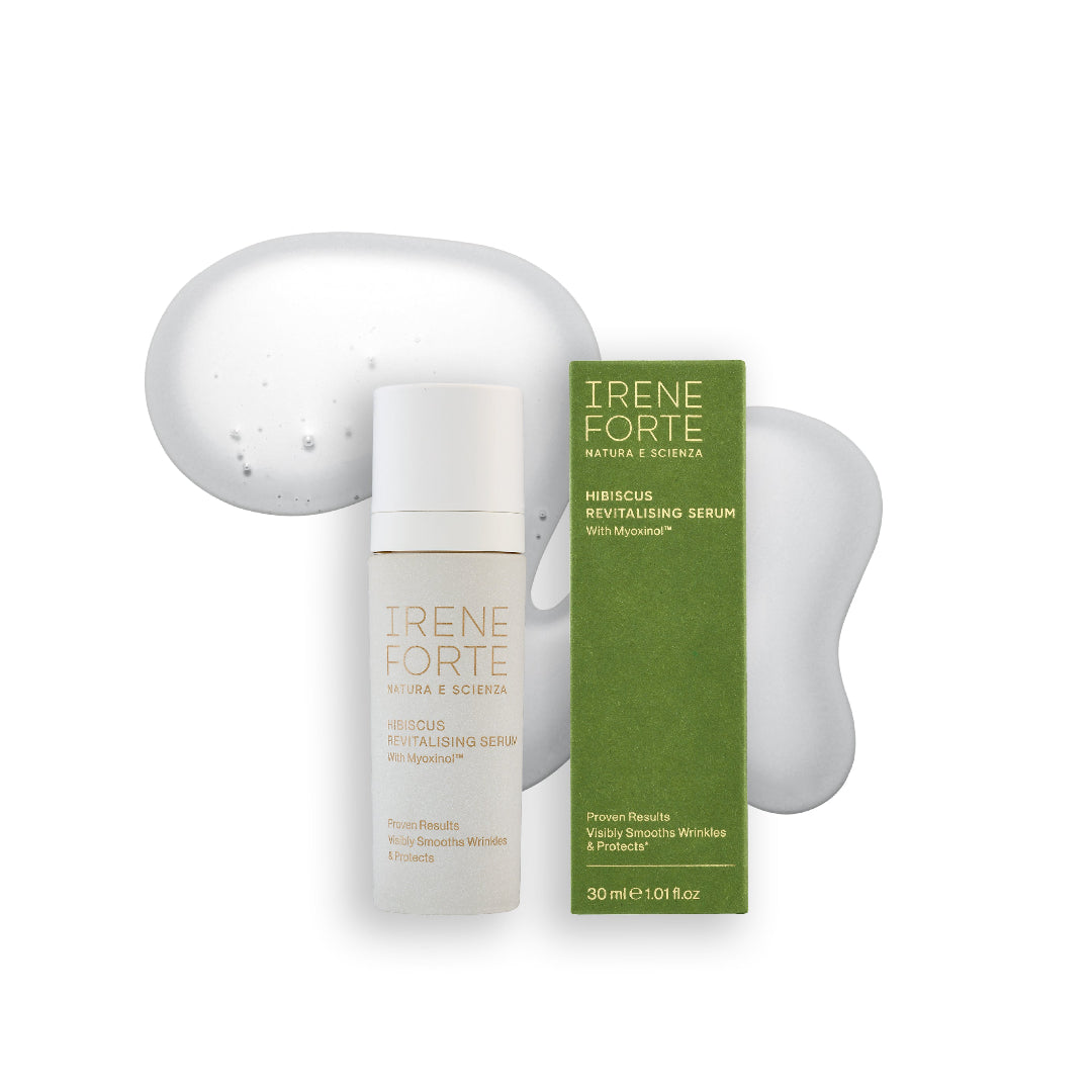 Irene Forte Hibiscus Revitalising Serum shown with its white bottle and green box packaging, set against a clean white background with decorative translucent gel shapes.