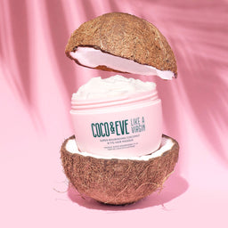 Coco & Eve Like A Virgin Super Nourishing Coconut & Fig Hair Masque between two coconut halfs