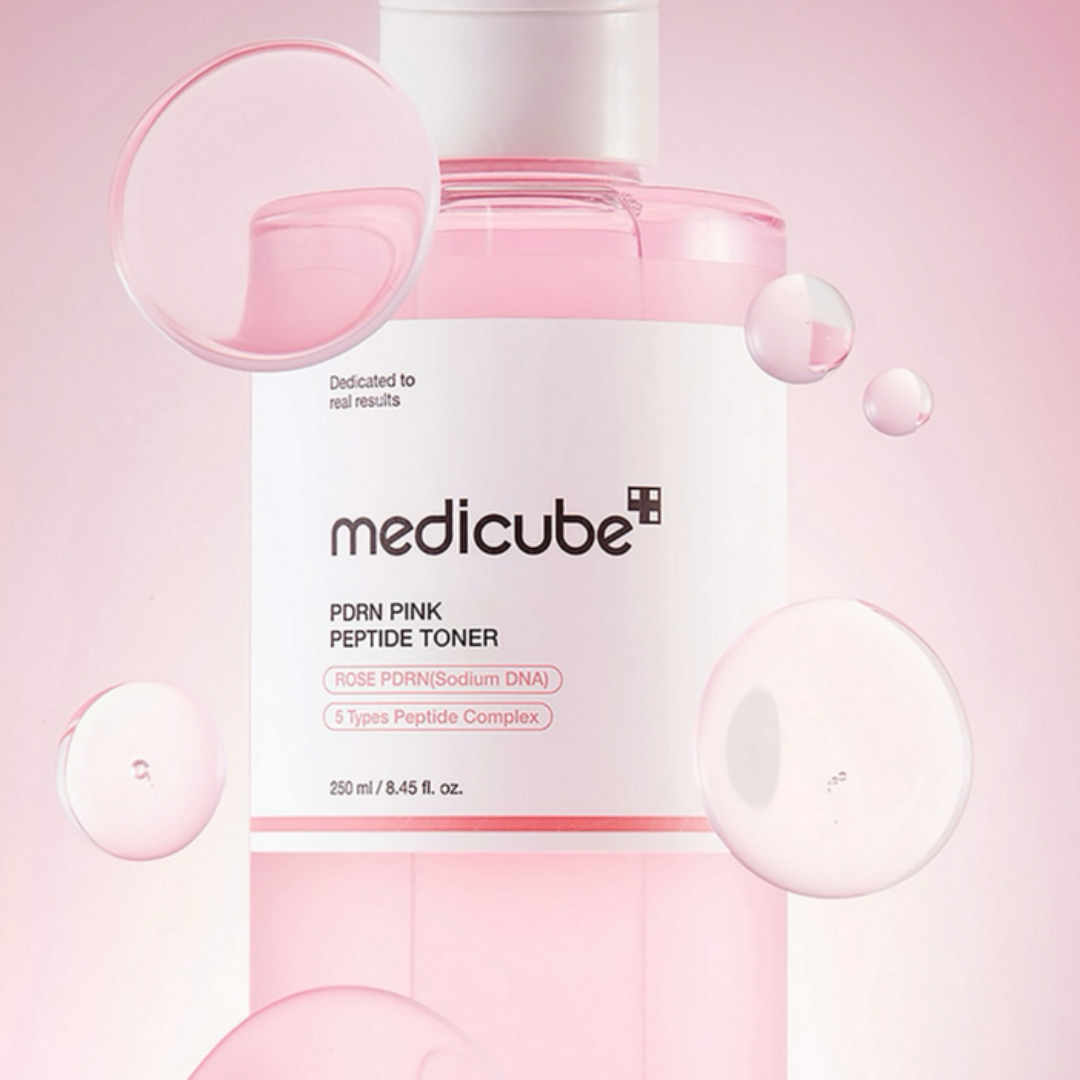 Medicube pink peptide toner bottle on a pink background