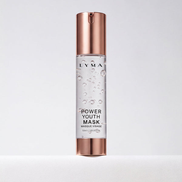 A bottle of Lyma Power Youth Mask (Mascarée Vraie) featuring a clear cylindrical body with visible liquid and bubbles, topped with a metallic rose gold cap and base, set against a clean white background.