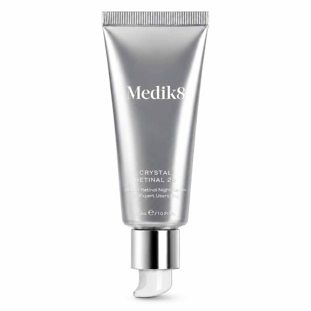 Medik8 Crystal Retinal 240 Retinol Night Serum in a sleek, metallic silver squeeze tube with a reflective silver cap and a clear, curved applicator tip, set against a solid white background.