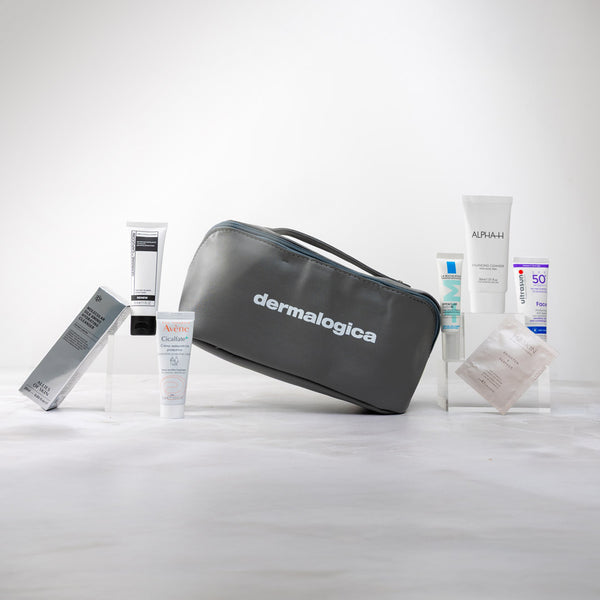 Dermalogica skincare products including a gray travel bag on a white background