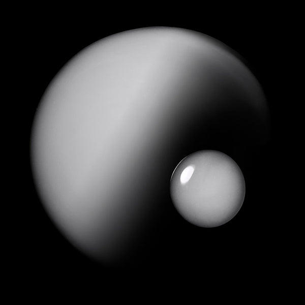 Two celestial bodies, one larger than the other, on a black background
