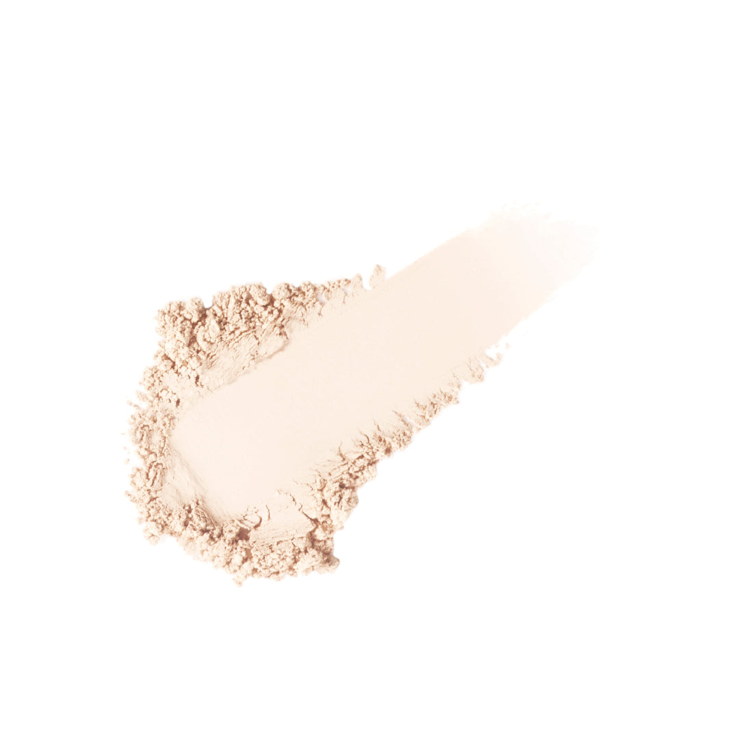 Makeup brush with beige powder on a white background