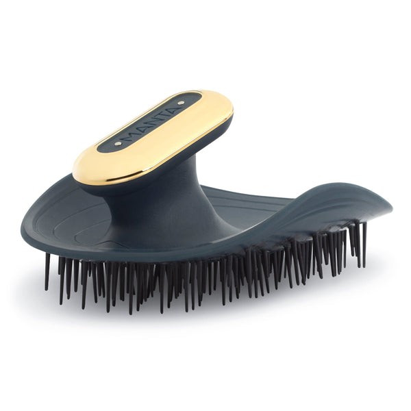 Pet grooming brush with gold and black design on a white background