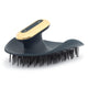 Pet grooming brush with gold and black design on a white background