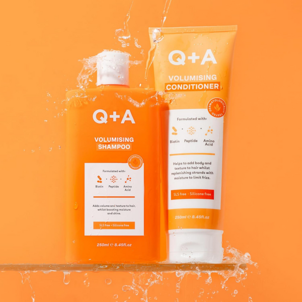 Q+A volumising shampoo and conditioner on an orange background