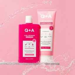 Q+A Curl Defining Shampoo and Conditioner on a pink background with water effects