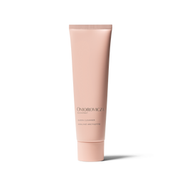 A single tube of Omorovicza Dispefy Skin Cleanser in a pale pink color, standing upright on a white background with a soft shadow.