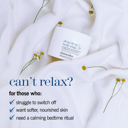 A white jar of thisworks Deep Sleep Body Whip body butter rests on soft white textured fabric with small yellow flowers scattered around it. Blue promotional text on the left reads, 'can’t relax? for those who: struggle to switch off, want softer, nourished skin, need a calming bedtime ritual.