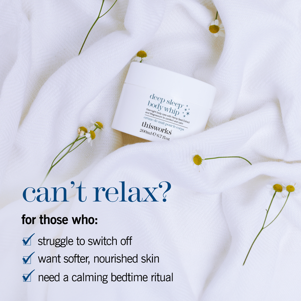 A white jar of thisworks Deep Sleep Body Whip body butter rests on soft white textured fabric with small yellow flowers scattered around it. Blue promotional text on the left reads, 'can’t relax? for those who: struggle to switch off, want softer, nourished skin, need a calming bedtime ritual.
