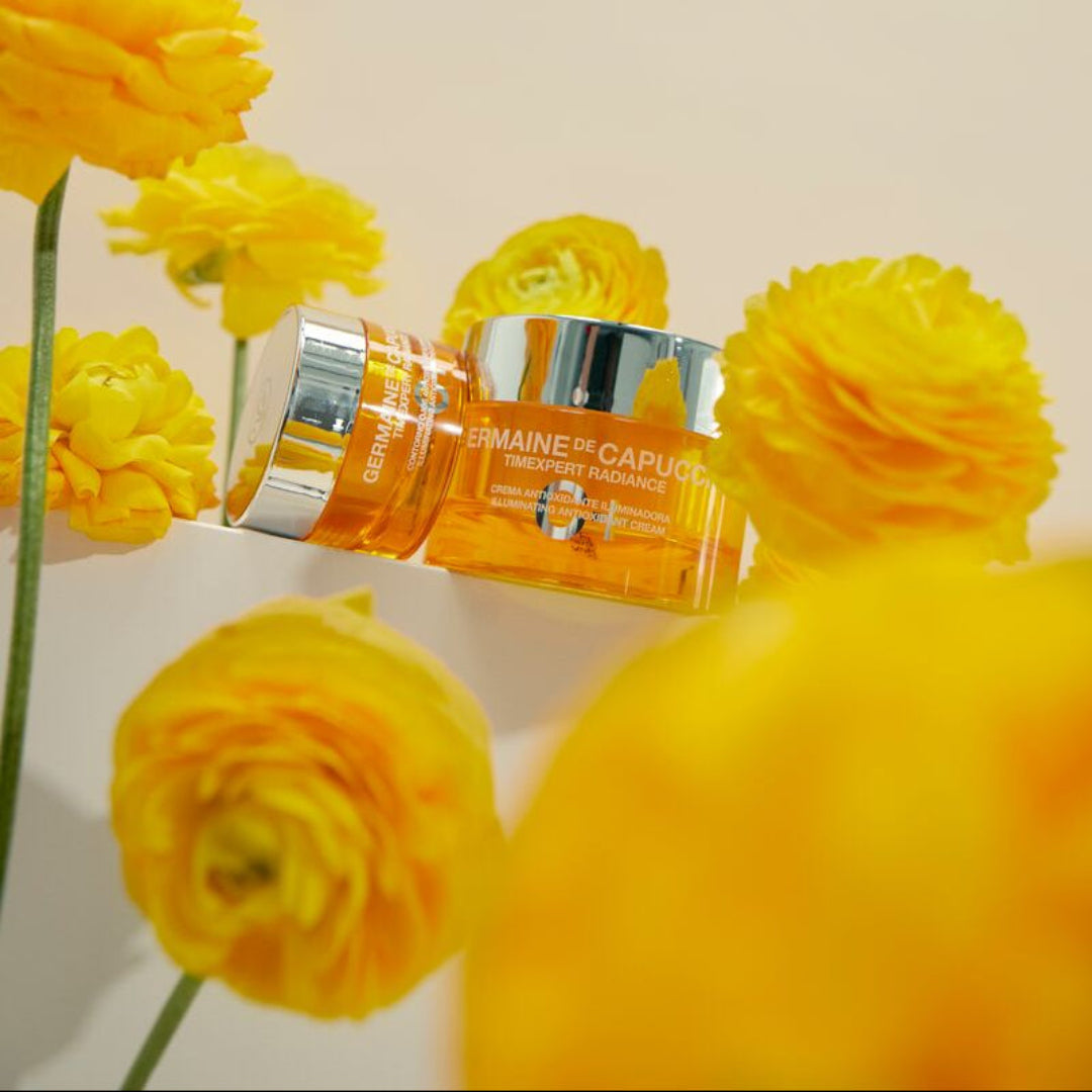 Two skincare products with yellow flowers on a light background