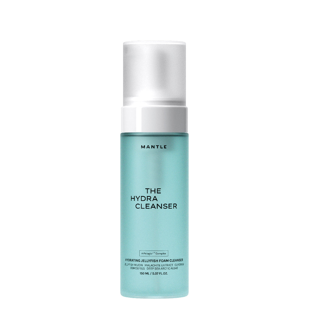 MANTLE The Hydra Cleanser hydrating jelly foam cleanser in a 100 ml glass bottle with a light aqua body, white pump, and white cap, set against a plain white background.