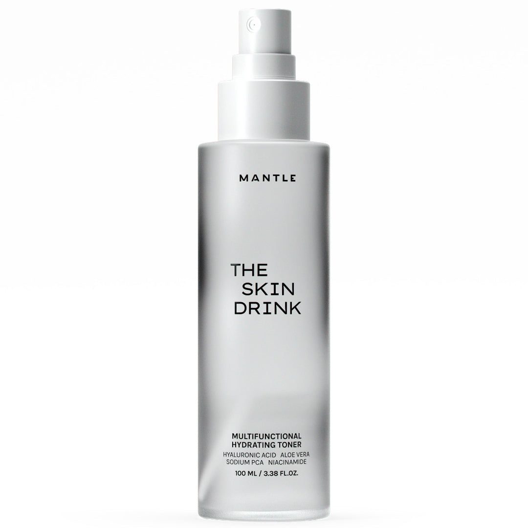 A 100 ml bottle of MANTLE The Skin Drink Multifunctional Hydrating Toner, featuring a frosted glass bottle and a white spray pump dispenser, shown against a plain white background.